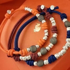 DoDo Bracciale Cordino Dieci granelli in argento e due pepite in titanio